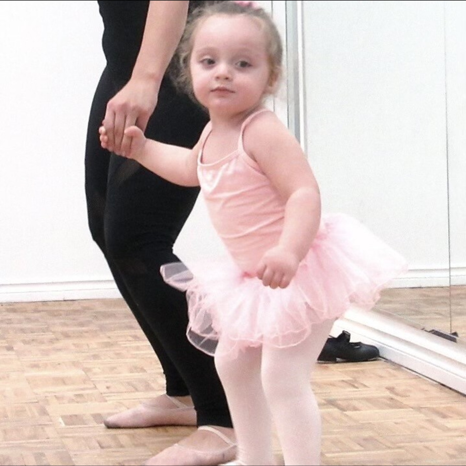 little girl learning dance via laptop dressed in pink